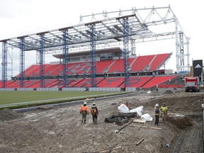 Workers walk through the football end zone at the north end of BMO Field on Wednesday February 3, 2016. Craig Robertson/Toronto Sun/Postmedia Network
