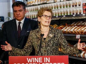Premier Kathleen Wynne along with Finance Minister Charles Sousa give an update on wine being sold in grocery stores across Ontario Thursday February 18, 2016 in Toronto. (Dave Thomas/Toronto Sun)