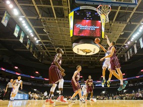Banting's Jackson Mayers goes up to block a layup by Beal's Hadi Akle during their boys AAA final at Budweiser Gardens in London, Ont. on Thursday February 18, 2016. 
The Bud wasn't a friendly barn for either team with Beal winning the low scoring game 39-28. (MIKE HENSEN, The London Free Press)