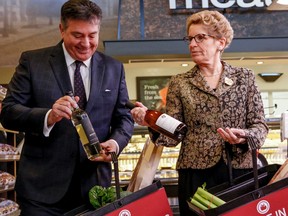 Premier Kathleen Wynne along with Finance Minister Charles Sousa give an update on wine being sold in grocery stores Thursday February 18, 2016 in Toronto. (Dave Thomas/Toronto Sun)