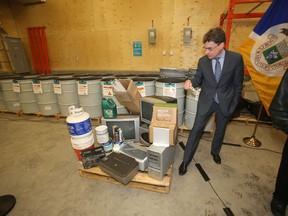 Coun. Brian Mayes looks at items deemed suitable for disposal at the Brady 4R Winnipeg Depot last year. (FILE PHOTO)