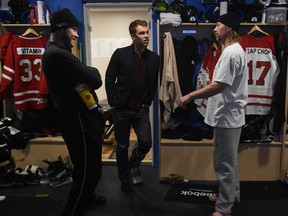 Janne Niinimaa, left, talks tio Taylor Hall and Brent Saik during last year's edition of the world's longest hockey game. (File)