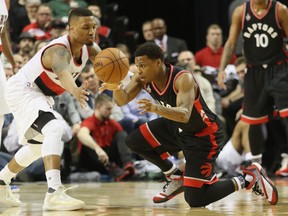 Portland Trail Blazers guard Damian Lillard and Toronto Raptors guard Kyle Lowry battle for a loose ball at Moda Center at the Rose Quarter in Portland on Feb. 4, 2016. (Jaime Valdez/USA TODAY Sports)