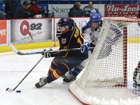 Barrie Colts defenceman Justin Murray protects the puck from Matt Schmalz of the Wolves during an OHL game in Sudbury this season. (John Lappa, Sudbury Star)