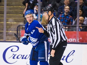 Toronto Maple Leafs forward Leo Komarov with linesman Scott Driscoll during first-period action against the New York Rangers in Toronto on Feb. 18, 2016. (Ernest Doroszuk/Toronto Sun/Postmedia Network)