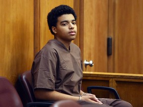 Marc Wabafiyebazu, 15, appears in adult criminal court for his arraignment, Monday, April 20, 2015, in Miami. Wabafiyebazu, the son of a Canadian diplomat charged with first-degree murder in a double killing in Miami, is expected to plead guilty to reduced charges Friday. (THE CANADIAN PRESS/Walter Michot/The Miami Herald via AP, Pool)