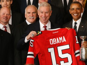President Barack Obama is presented with a replica Stanley Cup and honourary jersey by (from left) NHL deputy commissioner Bill Daly, Chicago Blackhawks head coach Joel Quenneville, president and chief operating officer John McDonough, and owner Rocky Wirtz at a ceremony in the East Room at the White House. (Geoff Burke/USA TODAY Sports)