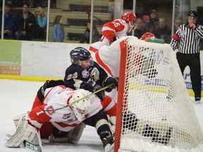 On the play above, Wolverines goaltender Garrett Mason stopped the puck, but couldn’t quite prevent Saints rookie Jack Hamly from speeding into the net during Spruce Grove’s 2-1 win on Feb. 15. The Family Day victory, in front of more than 1,200 fans, was capped off with a skate for kids and adults alike to lace ‘em up with the local Junior A team.  - Photo by Mitch Goldenberg