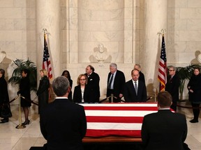 Mourners pay their respects while passing by the casket of U.S. Supreme Court Justice Antonin Scalia in the Great Hall of the Supreme Court in Washington February 19, 2016.  REUTERS/Gary Cameron