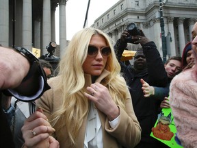 Pop star Kesha leaves Supreme court in New York, Friday, Feb. 19, 2016. Kesha is fighting to wrest her career away from a hitmaker she says drugged, sexually abused and psychologically tormented her _ and still has exclusive rights to make records with her. Producer Dr. Luke says the singer is slinging falsehoods and ruining his reputation to try to weasel out of her recording contract and strike a new deal.  (AP Photo/Mary Altaffer)