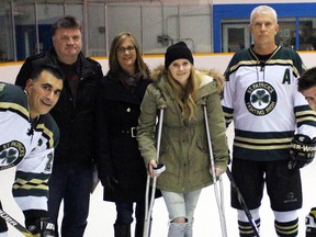 St. Pat's high school boy's hockey team played against their teachers in a fun game to raise money for Ronald McDonald House Charities and show support for Grade 10 student Taylor Scott, who was diagnosed with cancer in November, at Clearwater Arena on Friday February 19, 2016 in Sarnia, Ont. From left are St. Pat's principal Rob Cicchelli, Ian Scott, Christine Scott, Taylor Scott, teacher Blake Morrison, and Logan Scott. Terry Bridge/Sarnia Observer/Postmedia Network