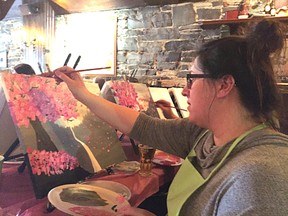 Amanda Morrison paints a Japanese cherry tree at Paint Nite on Wednesday. (Andrew Price/For The Whig-Standard)