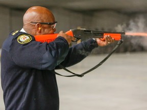 Toronto Police Chief Mark Saunders fires off a new less lethal shotgun that fires sock rounds. Media were invited to the Toronto Police College to see new, less-lethal training police officers are receiving on Friday, Feb. 19, 2016. Dave Thomas/Toronto Sun/Postmedia Network