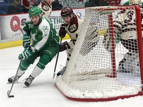 David Levin, left, of the Sudbury Wolves, looks for an opening while being pursued by Matthew Timms, of the Peterborough Petes, during OHL action at the Sudbury Community Arena in Sudbury, Ont. on Friday February 19, 2016. John Lappa/Sudbury Star/Postmedia Network