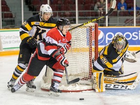 Ottawa's Artur Tyanulin drives around the net with Kingston Frontenacs goalie Jeremy Helvig keeping eye and Juho Lammikko chasing from behind in the first period of Ontario Hockey League action between the Ottawa 67s and the Kingston Frontenacs at TD Place on Friday night. (Wayne Cuddington/Postmedia Network)