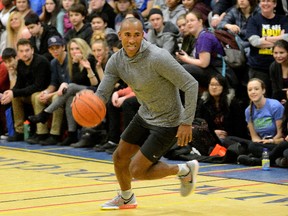 Canadian Olympian Damian Warner dribbles around pylons at Montcalm secondary school during a visit to his alma mater on Friday. (MORRIS LAMONT, The London Free Press)
