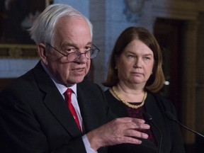 Minister of Immigration, Refugees and Citizenship John McCallum and Minister of Health Jane Philpott speak with the media in the Foyer of the House of Commons on Parliament Hill in Ottawa, February 18, 2016. (THE CANADIAN PRESS/Adrian Wyld)