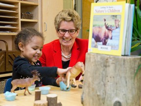 Ontario premier Kathleen Wynne plays with Aubrey Leader as she tours the White Oaks Family Centre before announcing the launch of Ontario Early Years Child and Family Centres. (CRAIG GLOVER, The London Free Press)