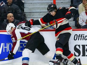 Ottawa Senators defenceman Cody Ceci checks Colorado Avalanche right winger Chris Wagner during NHL action in Ottawa on Feb. 11, 2016. (Errol McGihon/Postmedia)