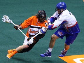 The Rock’s Brock Sorensen checks Mark Steenhuis of the Buffalo Bandits at the ACC Friday night. (Dave Abel/Toronto Sun)