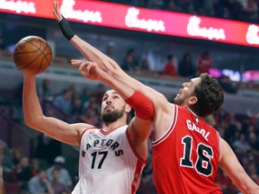 Toronto Raptors centre Jonas Valanciunas shoots past Chicago Bulls centre Pau Gasol during the first half of an NBA basketball game in Chicago on Feb. 19, 2016. (AP Photo/Charles Rex Arbogast)