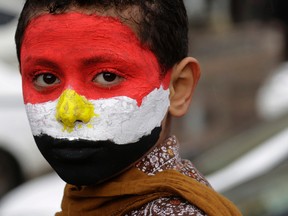 An Egyptian boy wears the colors of the national flag marking the anniversary of the 2011 uprising that toppled longtime ruler Hosni Mubarak, in Tahrir Square, Cairo, Egypt, Jan. 25, 2016. (AP Photo/Amr Nabil)