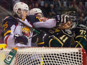Julius Nattinen  of the Barrie Colts punches Owen MacDonald of the London Knights during the first period of their OHL hockey game at Budweiser Gardens in London. Derek Ruttan/The London Free Press/Postmedia Network