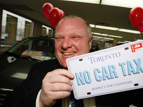 Then-mayor Rob Ford celebrating the end of the car tax back in 2011.  Craig Robertson/Toronto Sun/QMI Agency