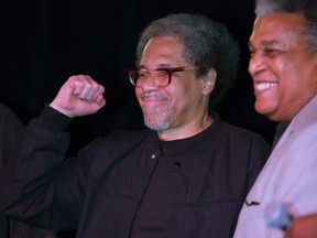 Albert Woodfox pumps his fist as he arrives on stage during his first public appearance at the Ashe Cultural Arts Center with Parnell Herbert, right, in New Orleans, Friday, Feb. 19, 2016, after his release from Louisiana State Penitentiary in Angola, La. earlier in the day. Woodfox is the last of three high-profile Louisiana prisoners known as the "Angola Three" to be released. (AP Photo/Max Becherer)