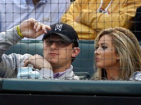 In this April 14, 2015, file photo, Cleveland Browns quarterback Johnny Manziel, left, sits with Colleen Crowley during a baseball game between the Los Angeles Angels and the Texas Rangers in Arlington, Texas. (AP Photo/LM Otero, File)
