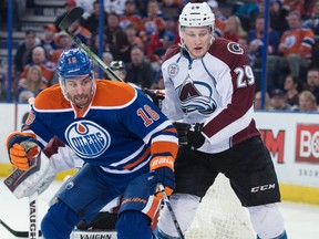Teddy Purcell battles Avalanche forward Nathan MacKinnon for the puck during the first period Saturday at Rexall Place. (Shaughn Butts)