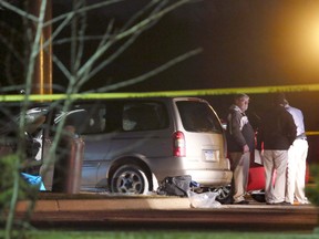 Police investigate the scene early Sunday, Feb. 21, 2016, where people were shot in vehicles outside a Cracker Barrel restaurant in Kalamazoo, Mich. A man drove around Kalamazoo shooting people at three locations Saturday, leaving six dead and three injured, two of them critically, police said. Police have arrested the suspect in the Saturday, Feb. 20, multiple shootings. (Mark Bugnaski/Kalamazoo Gazette)