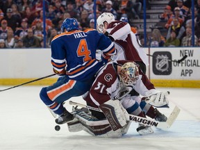 Edmonton Oilers left winger Taylor Hall  takes out Colorado Avalanche goalie Calvin Pickard on the way to a 3-2 Avs win at Rexall Place on Saturday.. (Shaughn Butts)