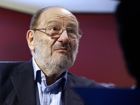 The late Italian author Umberto Eco appearas at a book signing in Paris last year. The writer, who earned an honourary doctorate from Laurentian University in 1995, died on Friday.