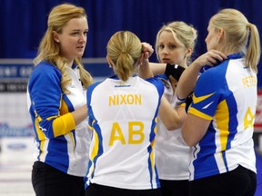 Team Alberta skip Chelsea Carey, left, speaks with her team during a timeout during the first draw of the Scotties Tournament of Hearts at Revolution Place in Grande Prairie, Alta. on Feb. 20, 2016. (Logan Clow/Grande Prairie Daily Herald-Tribune/Postmedia Network)