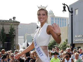In this Sept. 3, 2013, file photo Miss New Jersey Cara McCollum waves as she walks on a runway as Miss America contestants arrive in Atlantic City, N.J. McCollum was critically injured when her convertible spun off a highway and hit a tree, state police said Tuesday. (AP Photo/Mel Evans, File)