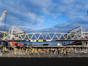 Steel workers prepare to mount the south canopy on BMO Field on Sunday. (DAVE THOMAS, Toronto Sun)