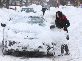 Doing the right thing: A woman clears off her car after a 50-cm snowfall in February, 2016