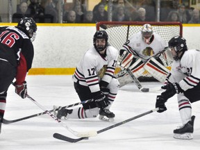 Mitchell Hawks defenceman Chad Lemire (17) drops to his knee to block this attempted shot on goal during Game 2 of their Western Jr. C semi-final series against visiting Walkerton last Saturday, Feb. 20. Tyler Pauli (21) of the Hawks is also pictured. ANDY BADER/MITCHELL ADVOCATE