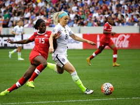 Julie Johnston (8) of the United States keeps Canada's Nichelle Prince (15) from the ball during first half CONCACAF Olympic women's soccer qualifying championship final in Houston on Sunday, Feb. 21, 2016. (David J. Phillip/AP Photo)