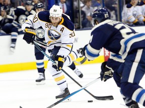 Sabres forward Ryan O'Reilly (left) shoots as Blue Jackets' Ryan Murray defends during third period NHL action in Columbus on Friday, Feb. 19, 2016. (Jay LaPrete/AP Photo)