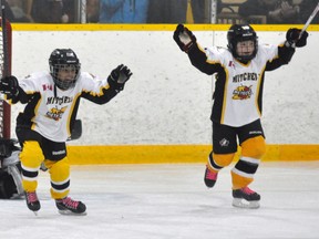 Kara Rolph (left) and Ashley McLeod of the Mitchell Novice girls hockey team celebrate Rolph’s third period goal which clinched their 2-0 win over visiting Ilderton last Saturday, Feb. 20. ANDY BADER/MITCHELL ADVOCATE