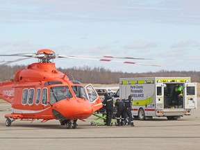 Perth County paramedics transfer a patient to an Ornge air ambulance at the Stratford airport Monday morning after two people were seriously injured in an apparent carbon monoxide leak at a business in Mitchell. The patient was airlifted to Hamilton to receive treatment in a hyperbaric chamber, which helps remove carbon monoxide from the blood. Mike Beitz/Stratford Beacon Herald/Postmedia Network