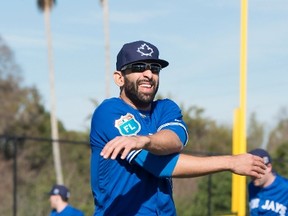 Toronto Blue Jays outfielder Jose Bautista stretches his arms in the first official workout of spring training in Dunedin, Fla., on Monday February 22, 2016. (THE CANADIAN PRESS/Frank Gunn)