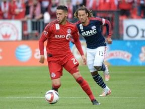 TFC's Jonathan Osorio fights for the ball against New England Revolution's Jermaine Jones during first-half MLS soccer action at BMO Field in Toronto on Sept. 13, 2015. (THE CANADIAN PRESS/Jon Blacker)