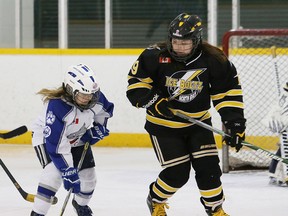 Katie Pilotte, left, of the Sudbury Lady Wolves, battles for the puck with Haley Manitowabi, of the North Bay Ice Boltz, during hockey action at Cambrian Arena in Sudbury, Ont. on Saturday February 20, 2016.