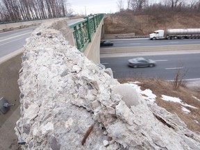 Cracked and crumbling concrete is seen on the Dorchester Road overpass as trucks speed beneath on Highway 401 east of London, Ont. on Monday February 22, 2016. (CRAIG GLOVER, The London Free Press)
