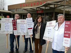 Registered nurses James Gibbons, Alan Warrington, Kathy Burgess, and union head James Murray, l-r, in front of the emergency department of Victoria Hospital.  Photo taken on Monday Feb 22, 2016 (MORRIS LAMONT, The London Free Press)