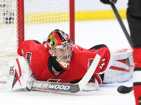 Craig Anderson of the Ottawa Senators looks around after making a save against the Detroit Red Wings during second-period NHL action at the Canadian Tire Centre in Ottawa on Feb. 20, 2016. (Jean Levac/Postmedia)