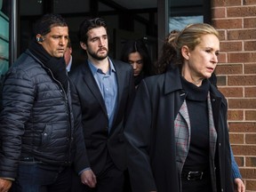 Marco Muzzo (centre) leaves the Newmarket courthouse surrounded by family members including his mother Dawn Muzzo (right) on Thursday, February 4, 2016. Muzzo was released on bail after pleading guilty to a fatal drunk driving crash resulting in the deaths of three children and their grandfather. (THE CANADIAN PRESS/ Christopher Katsarov)